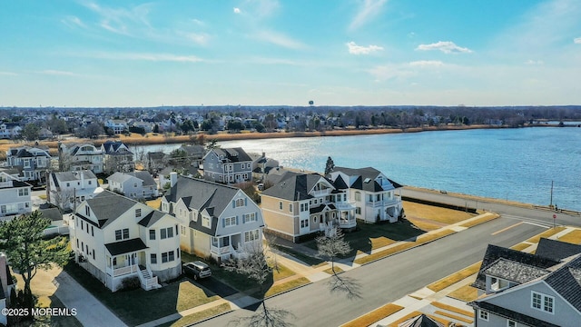 bird's eye view featuring a residential view and a water view