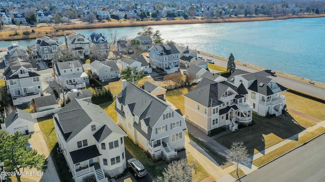 bird's eye view featuring a water view and a residential view