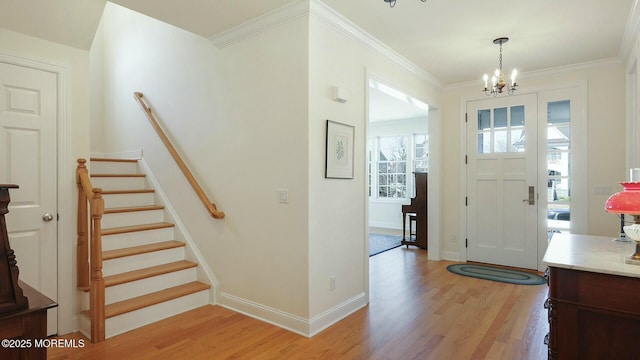 foyer entrance with stairway, light wood-style flooring, and baseboards