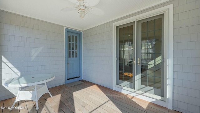 wooden terrace with a ceiling fan