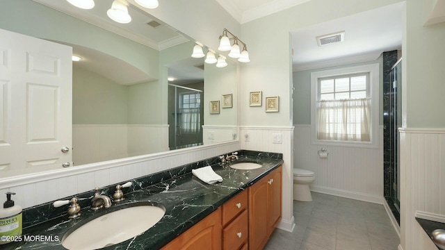 full bathroom featuring a wainscoted wall, visible vents, and a sink