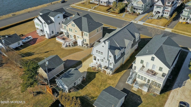 drone / aerial view featuring a water view and a residential view