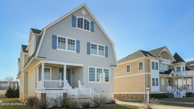 view of front of property featuring covered porch and a gambrel roof