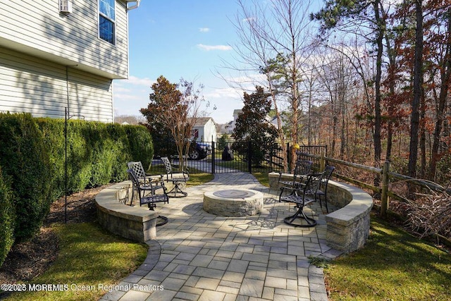 view of community featuring a patio area, fence, and a fire pit