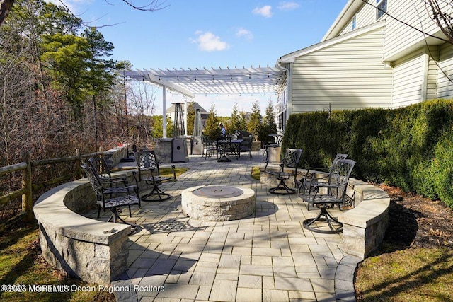 view of patio with an outdoor fire pit, fence, and a pergola