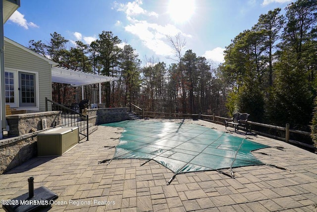 view of swimming pool featuring a patio, a fenced in pool, and a pergola