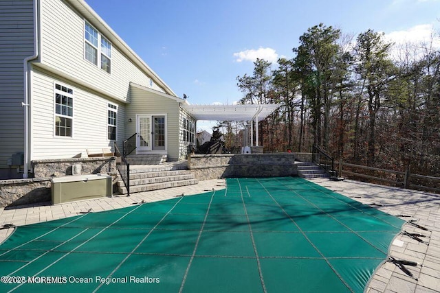 view of pool featuring a patio, entry steps, fence, a pergola, and a covered pool