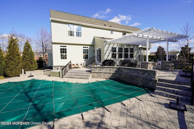 exterior space with a patio, area for grilling, entry steps, a pergola, and a covered pool