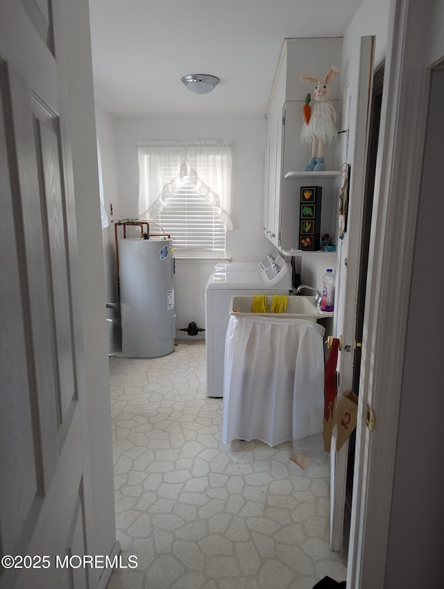 clothes washing area with light floors, cabinet space, washing machine and dryer, and electric water heater