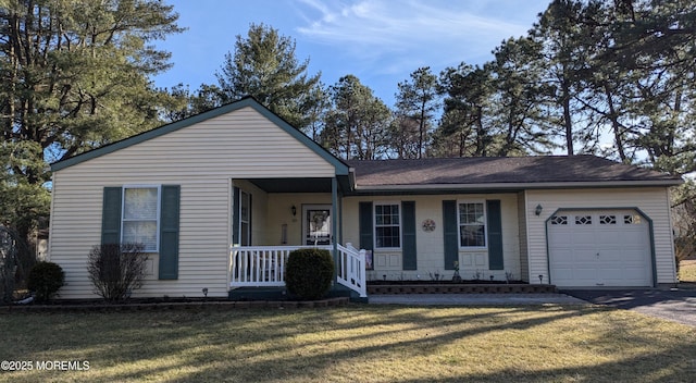 view of front facade with a garage, driveway, a porch, and a front lawn