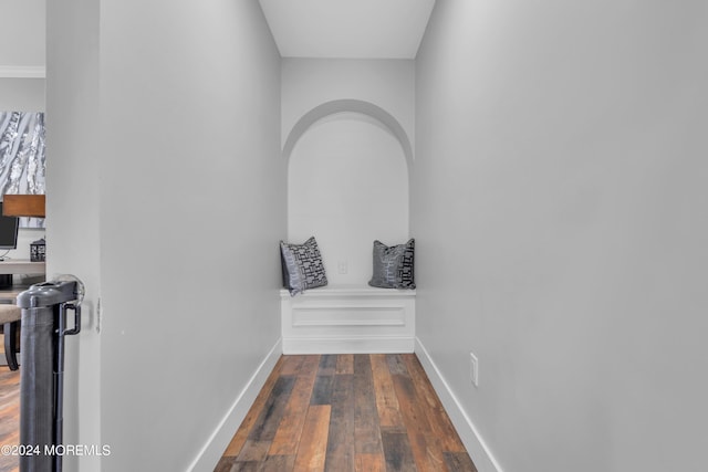 corridor with baseboards and hardwood / wood-style floors