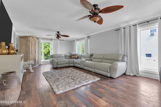 living area with ceiling fan, crown molding, a textured ceiling, and hardwood / wood-style flooring