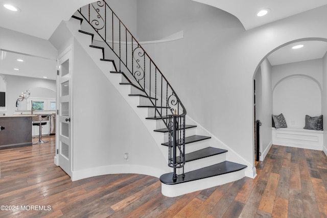 stairs featuring recessed lighting, baseboards, and hardwood / wood-style floors