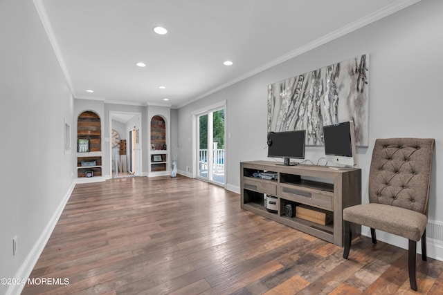 sitting room featuring baseboards, hardwood / wood-style floors, and ornamental molding