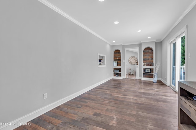 unfurnished living room featuring ornamental molding, dark wood-type flooring, a fireplace, and baseboards