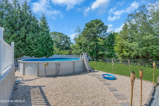 view of pool with a lawn, a fenced backyard, and a fenced in pool