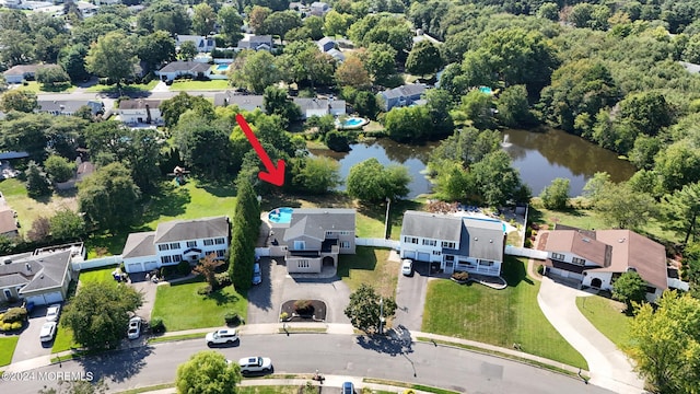 birds eye view of property with a residential view and a water view