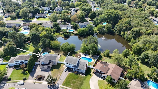 drone / aerial view with a water view and a residential view