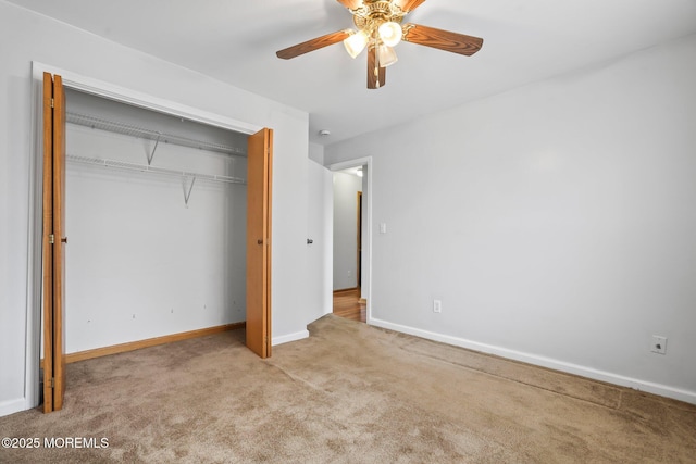 unfurnished bedroom with a ceiling fan, a closet, carpet flooring, and baseboards