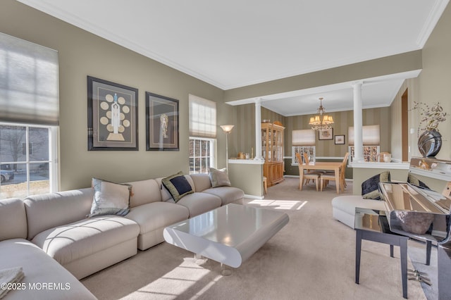 living area with a wealth of natural light, light colored carpet, a notable chandelier, and ornate columns