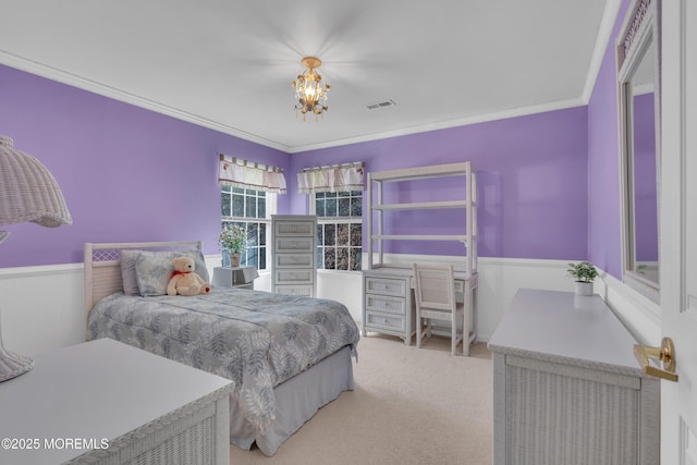 carpeted bedroom featuring a wainscoted wall, visible vents, crown molding, and a notable chandelier