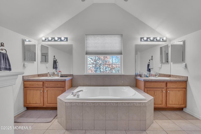 full bathroom with vaulted ceiling and a sink