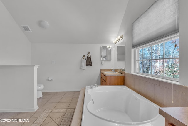 full bathroom featuring visible vents, toilet, tile patterned floors, a garden tub, and vanity