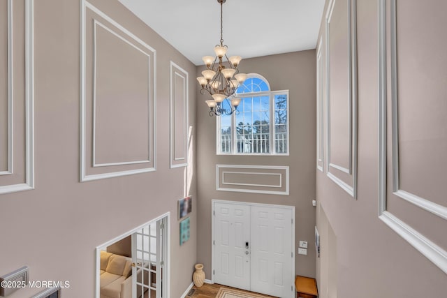 foyer entrance with a notable chandelier