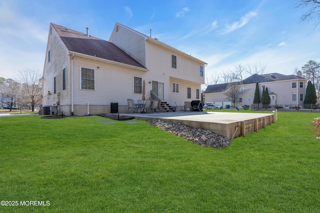 rear view of house with central air condition unit, a yard, entry steps, and a patio