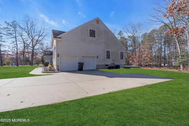 view of side of home featuring a lawn, driveway, and an attached garage