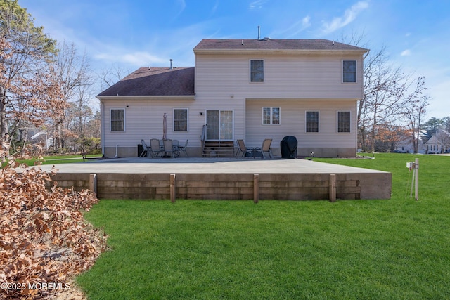 back of property featuring a lawn and a patio area