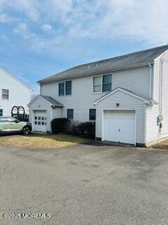 view of front of house with aphalt driveway and a garage