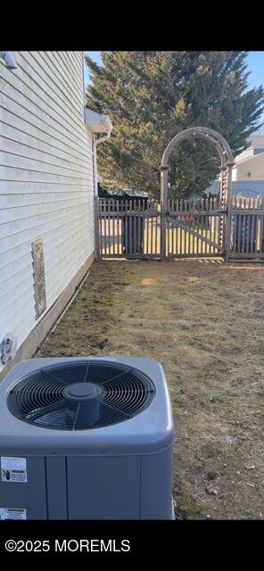 details featuring central AC unit and fence