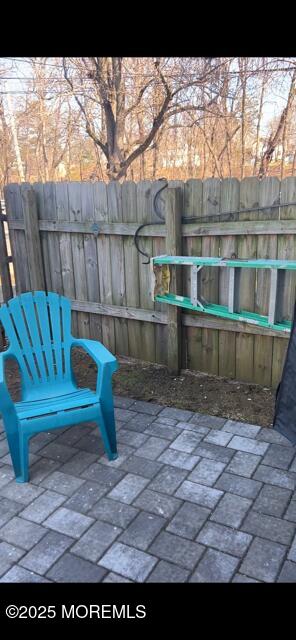 view of patio featuring fence