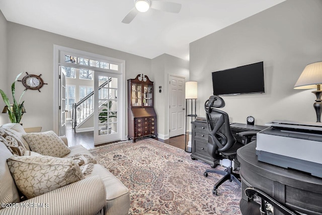 home office with a ceiling fan and baseboards