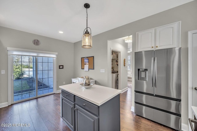 kitchen featuring dark wood-style flooring, stainless steel refrigerator with ice dispenser, gray cabinets, light countertops, and white cabinetry