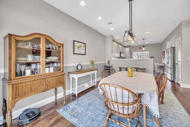 dining space featuring dark wood-style floors, baseboards, visible vents, and recessed lighting