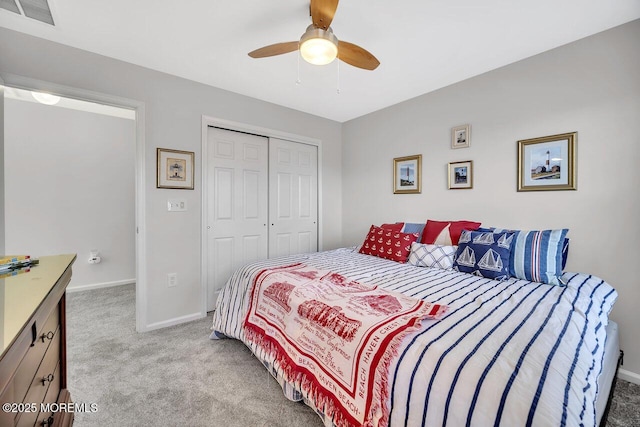 carpeted bedroom featuring baseboards, visible vents, ceiling fan, and a closet