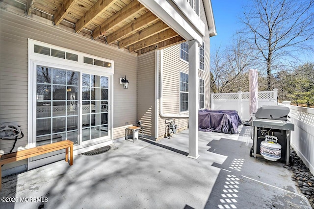 view of patio with a grill and fence