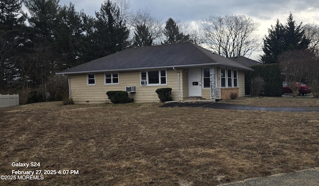 ranch-style home with a front yard, crawl space, and fence