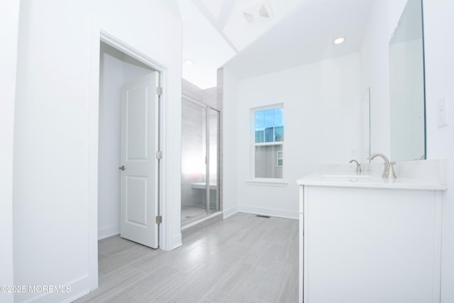 full bathroom featuring a shower stall, baseboards, and vanity