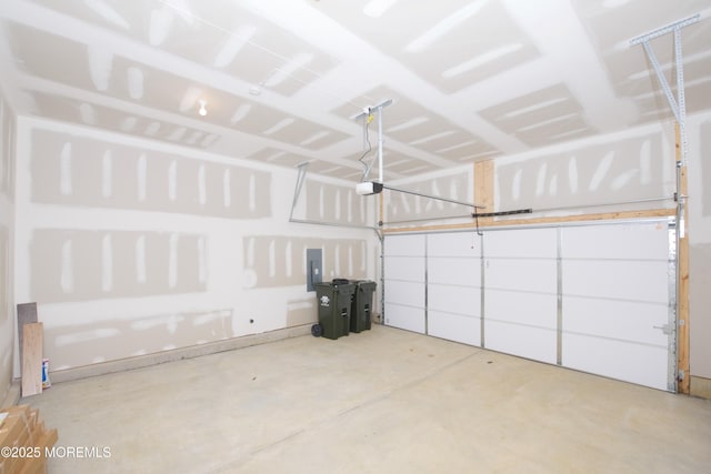 garage featuring electric panel and a garage door opener