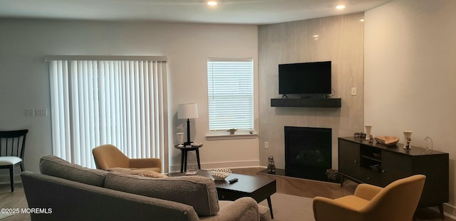 living room featuring a fireplace and recessed lighting