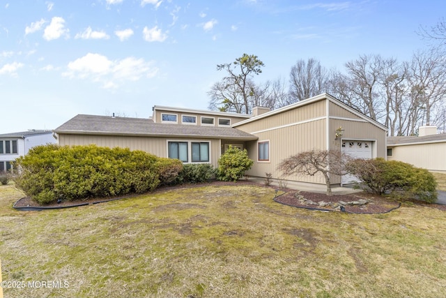 mid-century home with a garage and a front lawn