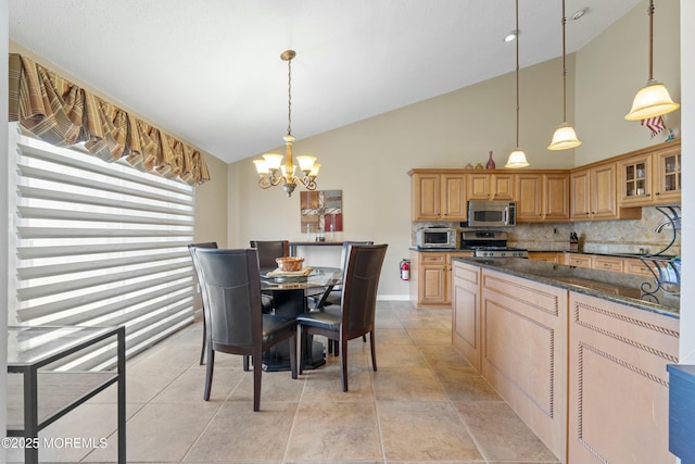 kitchen with glass insert cabinets, appliances with stainless steel finishes, tasteful backsplash, decorative light fixtures, and an inviting chandelier