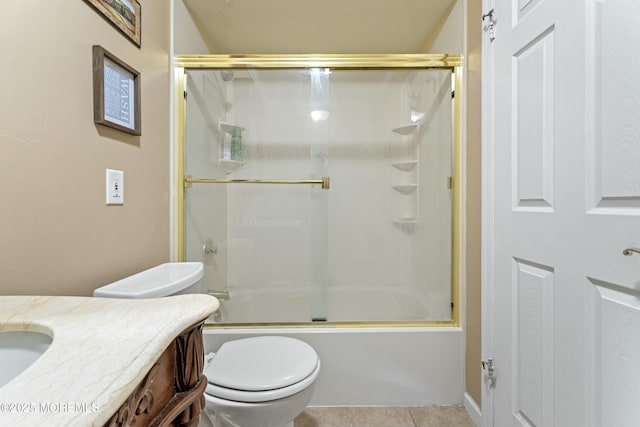 full bathroom with shower / bath combination with glass door, vanity, toilet, and tile patterned floors