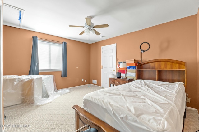 bedroom featuring a ceiling fan, carpet, and baseboards