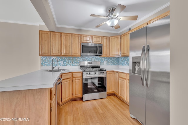 kitchen with stainless steel appliances, light wood-style flooring, light brown cabinetry, ornamental molding, and a sink