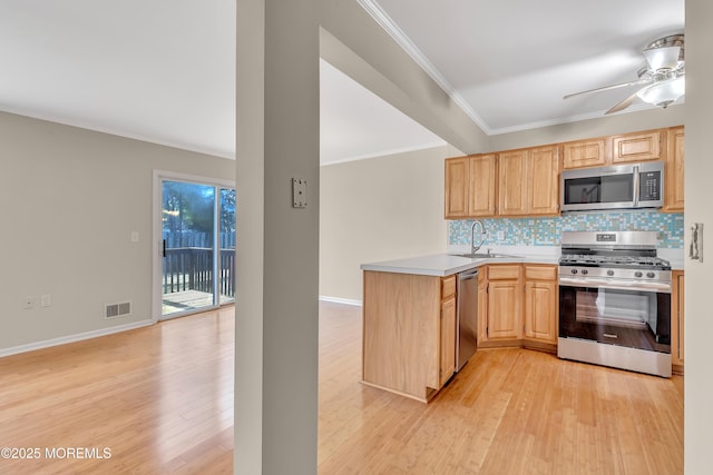 kitchen with tasteful backsplash, visible vents, light brown cabinetry, appliances with stainless steel finishes, and a peninsula