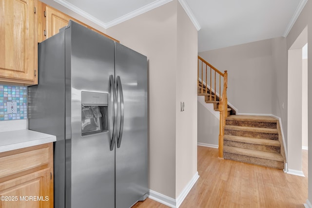 kitchen featuring ornamental molding, tasteful backsplash, light brown cabinets, and stainless steel fridge with ice dispenser